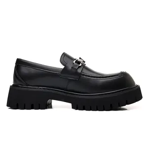 Side profile of men's chunky black loafers with thick platform soles and buckle detail.