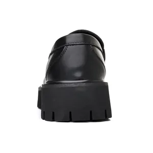 Close-up rear view of stylish black men's loafers featuring a thick platform sole