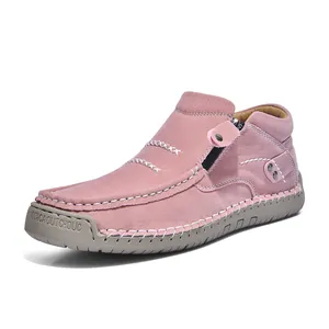 Detail of pink high-top leather casual shoe with side zipper and white stitching.