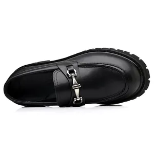 Detailed top view of black men's leather loafers with thick soles and metal buckle accents