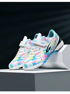 Detailed view of kids white soccer shoes featuring vibrant colorful splash patterns