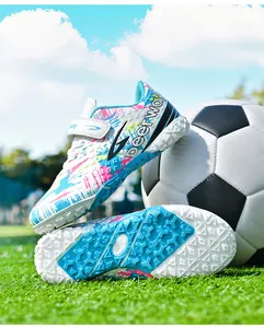 Vibrant colorful turf soccer cleats for kids featuring durable rubber soles and graffiti design