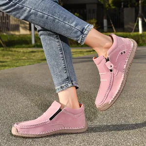Close-up of pink handmade suede loafers with side zipper and durable rubber sole