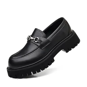 Detailed view of men's black leather platform loafers with metallic bit and lug sole