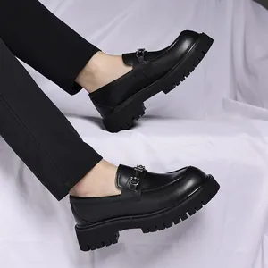 Detailed view of men's chunky platform loafers featuring a stylish metal buckle.
