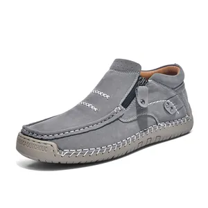 Close-up of handmade gray suede high-top casual shoe with side zipper and white stitching.