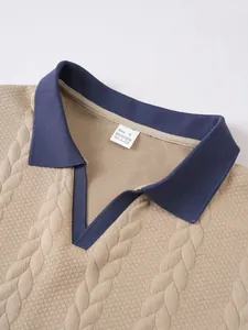 Close-up of navy blue polo collar and jacquard knit texture of tan business t-shirt