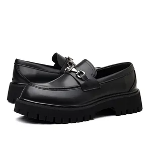 Close-up of black chunky men's loafers with thick lug soles and silver buckle detail