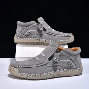 Close-up of grey suede high-top casual shoes with zipper and hand-stitched details