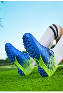 Detailed view of blue and neon green kids turf soccer shoes with velcro straps