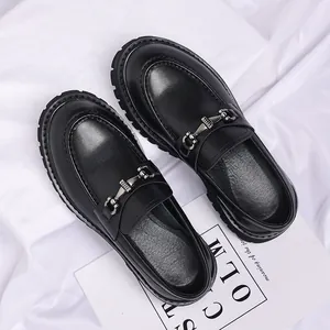 Detailed view of premium men's black thick-sole loafers with stylish metal bit ornament