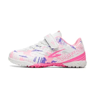 Professional white and pink kids TF turf soccer shoes for outdoor grass training
