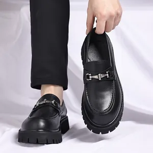 Detail of men's chunky black loafers with silver bit and thick lug sole