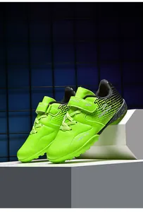 Vibrant neon green children's TF soccer shoes with velcro straps for artificial turf