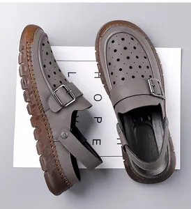 Top-down view of grey men's sandals with laser-cut holes and adjustable buckle strap