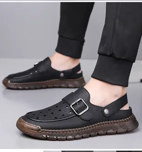 Detailed side view of men's black hollow-out leather clogs featuring a buckle and chunky sole
