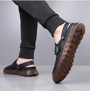 Close-up detail of men's black non-slip outdoor clogs featuring a textured brown sole