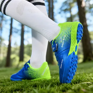 Blue and lime green children's soccer shoes with TF turf soles and velcro straps.