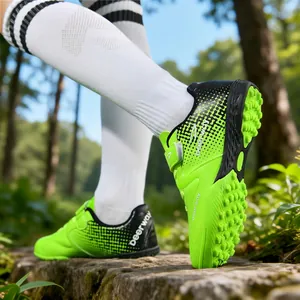 Lime green kids' TF soccer shoes with velcro straps for artificial grass training.