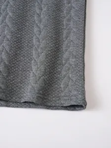 Detailed macro shot showing gray jacquard fabric texture and hem of a men's polo shirt