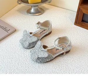 Detailed view of silver glitter girl's Mary Jane shoes with large butterfly motif