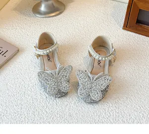 Detailed view of silver glitter girls princess shoes with large butterfly and pearls