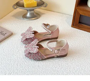 Detailed view of pink glittery girls princess shoes with sparkling rhinestone butterfly