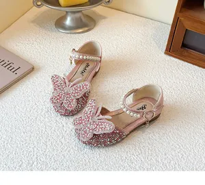 Detail of pink girls princess shoe featuring a sparkling butterfly and pearl strap