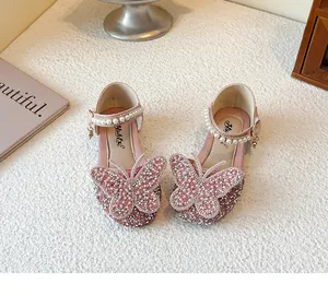 Detailed view of pink princess shoes featuring rhinestone butterflies and pearl straps