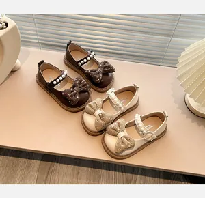Detalle de zapatos Mary Jane para niña con lazos florales y correas de perlas