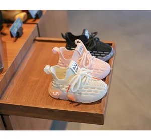Detail showing breathable kids yeezy style sneakers in cream, pink and black colors