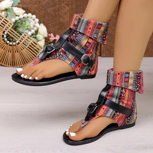 Close-up of bohemian style sandals with colorful patterned ankle wrap and buckle straps