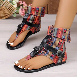 Detail of bohemian ethnic print sandals with black buckle straps and flat soles