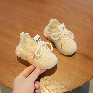 Breathable cream baby sneakers with soft soles and knitted design for toddlers