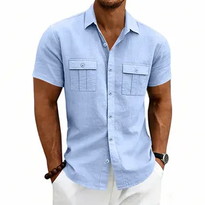 Detail of a light blue men's linen short-sleeve shirt with functional flap chest pockets.