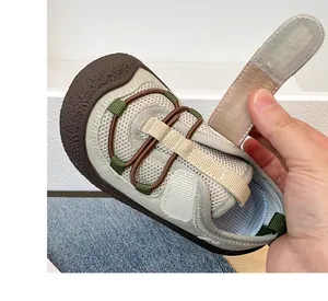 Detail view of breathable mesh material and adjustable velcro strap on kids shoe