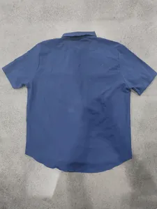 Detailed back view of a men's casual navy blue linen short-sleeved workwear shirt