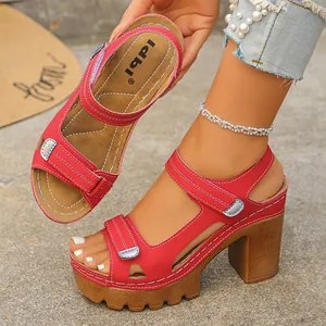 Detailed macro view of stylish red platform sandals with white stitching and velcro straps