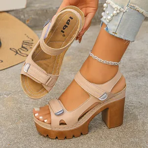 Detail of beige platform sandal with velcro straps and chunky high heel on model