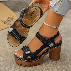 Detailed view of black platform sandals featuring chunky heels and adjustable velcro straps