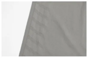 Macro detail showing the seamless breathable knit pattern of a grey men's sports t-shirt fabric