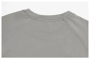 Close-up of gray men's sports top neckline and seamless raglan sleeve stitching.