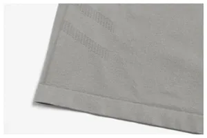 Detailed view of gray seamless quick-dry sports top with mesh breathable texture.