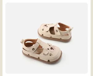 Detailweergave van schattige crème peutersandalen met beerontwerp en zachte antislipzool