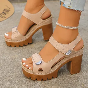 Close-up of beige platform sandals with chunky heels and velcro straps.