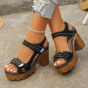Detailed view of women's black platform sandals with velcro straps and block heels