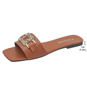 Side view of brown flat sandals showing 1cm heel height and rhinestone buckle detail