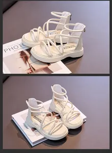 Vista dettagliata degli eleganti sandali alla romana alti da bambina color crema con suola morbida