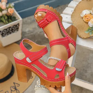 Close-up detail of red chunky heel platform sandals with adjustable Velcro straps