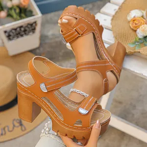 Brown chunky high-heel platform sandals with adjustable velcro straps and white stitching
